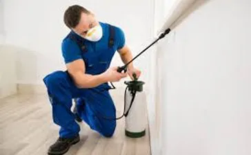 Pest control technician treating for rodents in a Melbourne home